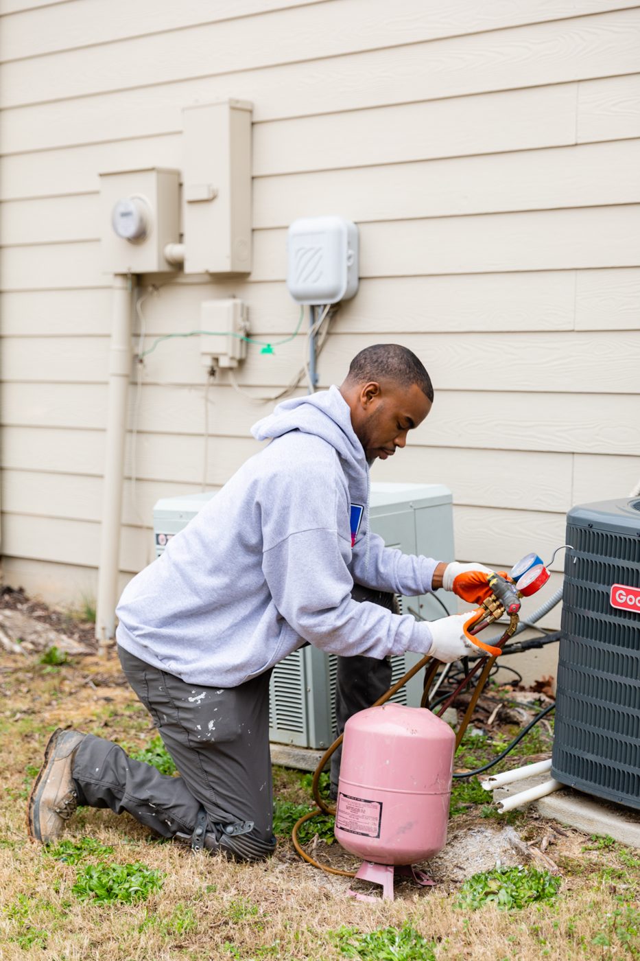 Technician servicing an AC unit